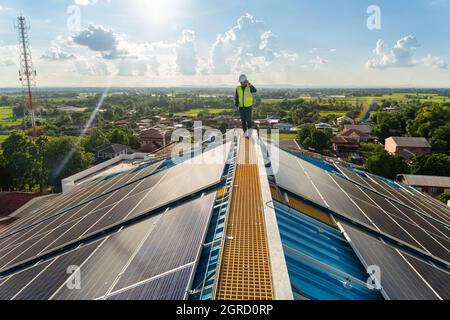 An engineer inspect solar panels on the roof, Maintenance solar roof, solar power. Stock Photo