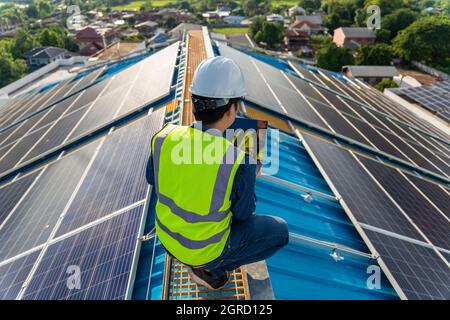 Maintenance solar power, engineer working, operation and maintenance in solar power plant on rooftop. clean energy Stock Photo