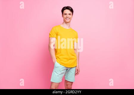 Photo of young handsome guy happy positive smile confident hand in pocket casual outfit isolated over pink color background Stock Photo