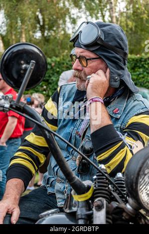 Characterful motorcycle rider at the Goodwood Revival 2014. Member of the Hornets motorcycle gang. Retro American 1950s style biker Stock Photo