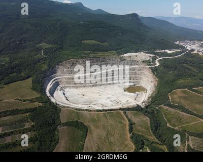 Aerial view industrial of opencast mining quarry with lots of machinery at work - crushed stone and building materials for the constractions industry Stock Photo