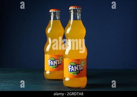 Odessa, Ukraine - September 23, 2021: Fanta bottles on wooden table against blue background Stock Photo