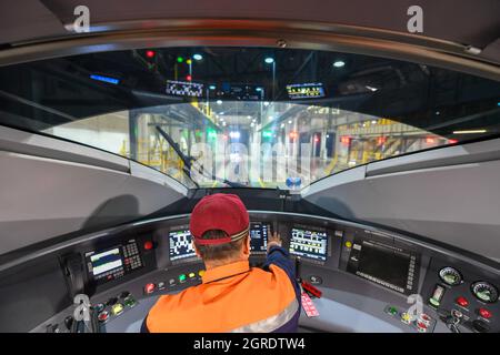 Changchun, China's Jilin Province. 1st Oct, 2021. Technician He Hailong runs a data test at the driving cabin of a high-speed train at a maintenance base in Changchun, northeast China's Jilin Province, Oct. 1, 2021. Credit: Zhang Nan/Xinhua/Alamy Live News Stock Photo