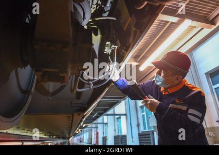 Changchun, China's Jilin Province. 1st Oct, 2021. Technician He Hailong checks a high-speed train at a maintenance base in Changchun, northeast China's Jilin Province, Oct. 1, 2021. Credit: Zhang Nan/Xinhua/Alamy Live News Stock Photo