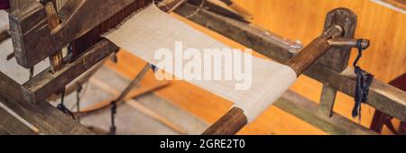 Village women busy weaving silk saree on handloom BANNER, LONG FORMAT Stock Photo