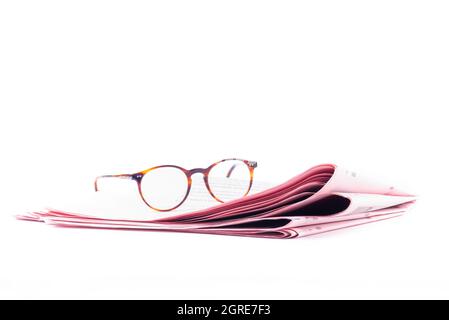 Italian sport newspapers and reading glasses isolated on white background Stock Photo