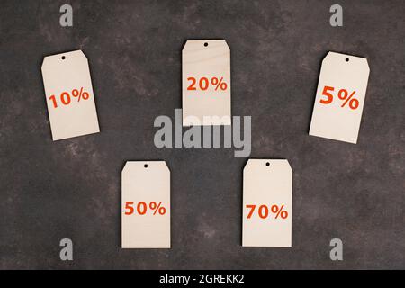 Price labels from with different discounts on a dark background Stock Photo