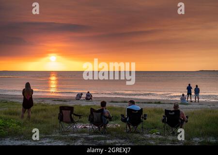 Tourist gathering daily on the beach to watch the sunset over Albatross Bay, Weipa, Far North Queensland Stock Photo