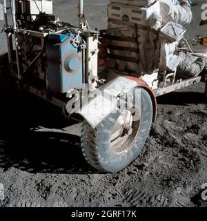 This photograph taken during the Apollo 17 mission (the last mission of the Apollo Program), depicts stiff plasticized maps being taped together and fastened by clamps to patch a broken fender of the Lunar Roving Vehicle (LRV). Powered by battery, the lightweight electric car greatly increased the range of mobility and productivity on the scientific traverses for astronauts. It weighed 462 pounds (77 pounds on the Moon) and could carry two suited astronauts, their gear and cameras, and several hundred pounds of bagged samples. The LRV's mobility was quite high. It could climb and descend slope Stock Photo