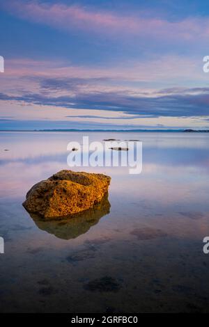 Rock exposed at low tide at dawn at Alau Beach, Alau Beach Campground, Umagico, Cape York Peninsula, North Queensland Stock Photo