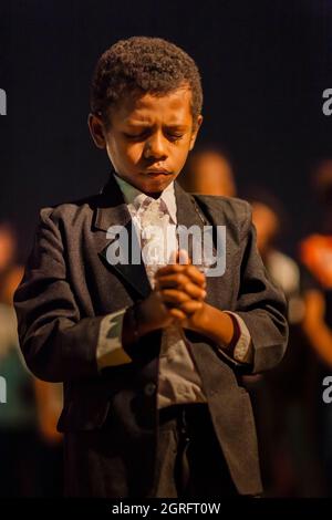 Indonesia, Papua, town of Sentani, evangelical mass, portrait of a young boy in prayer Stock Photo