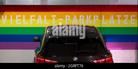 Hanau, Germany. 01st Oct, 2021. A car is parked in one of the 'diversity parking spaces' in the Am Markt underground car park. The three parking spaces, which are video-monitored and close to exits, were set up last week. They are marked by the rainbow colours on the wall. Credit: Sebastian Gollnow/dpa/Alamy Live News Stock Photo