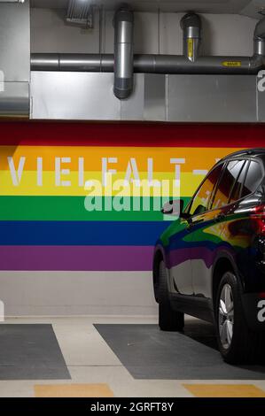 Hanau, Germany. 01st Oct, 2021. A car is parked in one of the 'diversity parking spaces' in the Am Markt underground car park. The three parking spaces, which are video-monitored and close to exits, were set up last week. They are marked by the rainbow colours on the wall. Credit: Sebastian Gollnow/dpa/Alamy Live News Stock Photo