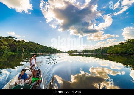 France, French Guiana, Parc Amazonien de Guyane, Camopi, Amerindian Teko family sailing on the Oyapock river, natural border with Brazil Stock Photo