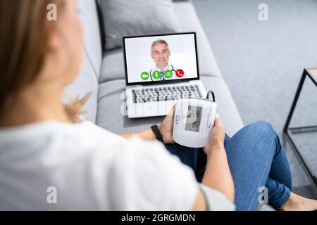 Patient Testing Blood Pressure In Telehealth Telemedicine Call Stock Photo