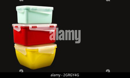 Lunch boxes made of eco plastic for easy storage of food in the kitchen. Isolated on black background. Stock Photo