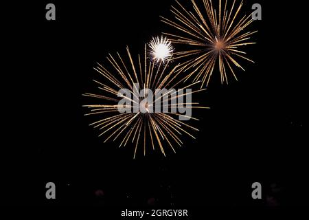 Low angle view of fireworks exploding against sky at night, Toledo, Spain Stock Photo
