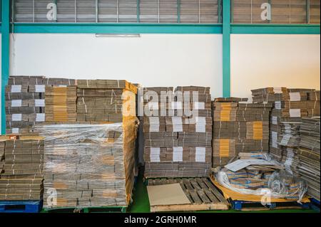 Stacked of flat pack cardboard boxes on pallet for product packaging and delivery in warehouse Stock Photo
