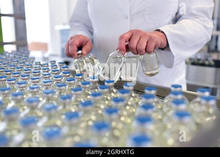 medical products manufacturing in a modern factory - glass bottles with medications on conveyor belt Stock Photo