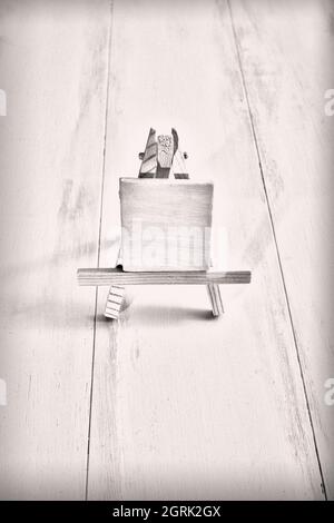 Wood easel or artwork board with white canvas over wooden background with copy space Stock Photo
