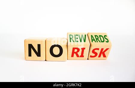 No risk or rewards symbol. Turned cubes and changed words 'no risk' to 'no rewards'. Beautiful white background. No risk or rewards and business conce Stock Photo