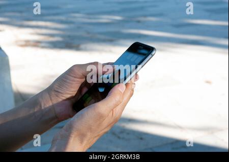 Woman while using the phone, touch the screen. Stock Photo