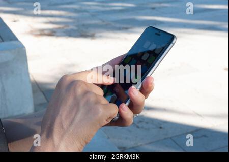 Woman while using the phone, touch the screen. Stock Photo