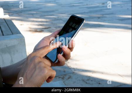 Woman while using the phone, touch the screen. Stock Photo
