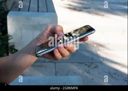 Woman while using the phone, touch the screen. Stock Photo