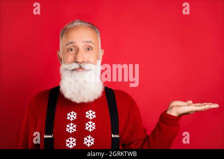Photo of pretty charming senior gentleman wear print pullover holding arm empty space isolated red color background Stock Photo