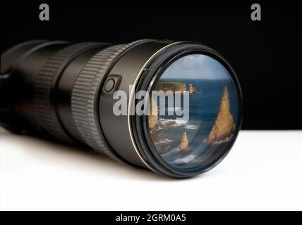 Digital zoom lens with landscape photo embedded on end, depicting concepts of the bigger picture, I spy, observation or the way forward Stock Photo