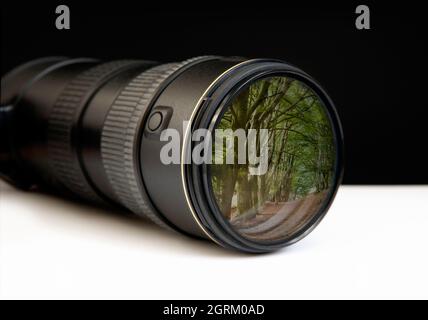 Digital zoom lens with landscape photo embedded on end, depicting concepts of the bigger picture, I spy, observation or the way forward Stock Photo