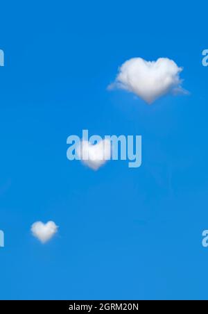 White, fluffy heart shaped clouds in bright blue sky. Concept of love ...