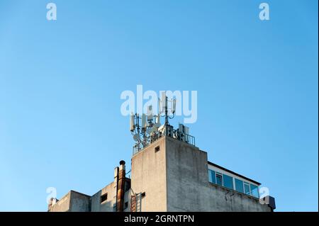 Communication antennas on the top of the building Stock Photo