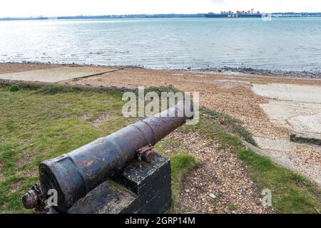Canon overlooking Southampton water at Weston Sailing Club Hampshire England with container ship in background Stock Photo