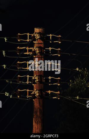 Limassol – Cyprus – September 1, 2021: Detail of old fashioned wooden electricity post Stock Photo