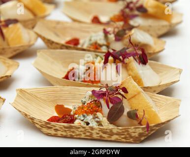 Cooking demonstration, table with food portions on display. Stock Photo