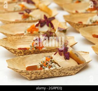 Cooking demonstration, table with food portions on display. Stock Photo