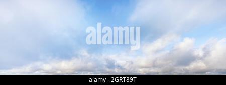 Bright blue cloudy sky at the horizon. Long panoramic view Stock Photo