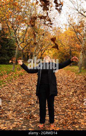 A Path In The Forest With Fallen Leaves And Trees Covered With Frost 