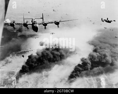 A Boeing B-24 Liberators flying through smoke during Operation Tidal Wave, the attacks on the Ploesto oil refineries in Romania Stock Photo