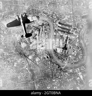 A German Luftwaffe Heinkel He 111 bomber flying over Wapping and the Isle of Dogs in the East End of London at the start of the Luftwaffe's evening raids of 7 September 1940. Stock Photo