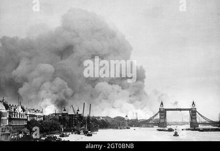 View along the River Thames in London towards smoke rising from the London docks after an air raid during the Blitz.following bombing on 7 September Stock Photo