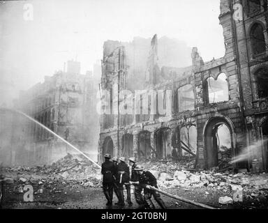 Firefighters putting out a blaze in London after an air raid during The Blitz in 1941. Stock Photo