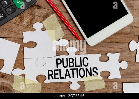 Handwriting text Public Relations. Word Written on state of the relationship between the public and a company Building An Unfinished White Jigsaw Stock Photo