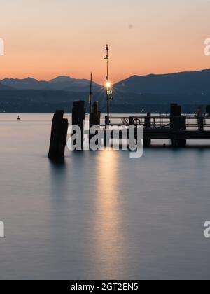 Sirmione Ferry Terminal Sunset on Lake Garda in the Evening or at Dusk Stock Photo