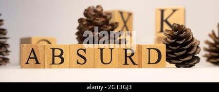 Absurd was created from wooden cubes. pine cone concept. concept. White background and close-up. Stock Photo