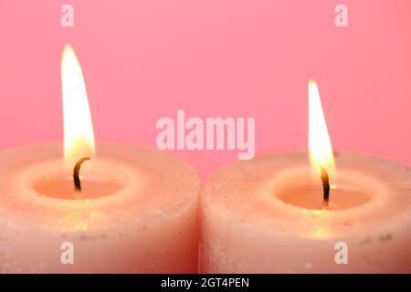 Candles set.Flame candles close-up Burning candles on a pink background. Stock Photo