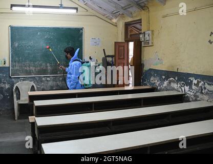 Mumbai, India. 01st Oct, 2021. A man wearing a Personal Protective Equipment (PPE) disinfects a classroom of a school in Mumbai. The Brihanmumbai Municipal Corporation (BMC) has issued an order to reopen the schools for class 8th to 10th from 4th of October with all protocols in place. (Photo by Ashish Vaishnav/SOPA Images/Sipa USA) Credit: Sipa USA/Alamy Live News Stock Photo