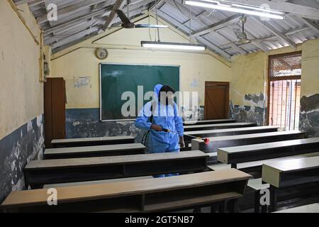 Mumbai, India. 01st Oct, 2021. A man wearing a Personal Protective Equipment (PPE) disinfects a classroom of a school in Mumbai. The Brihanmumbai Municipal Corporation (BMC) has issued an order to reopen the schools for class 8th to 10th from 4th of October with all protocols in place. (Photo by Ashish Vaishnav/SOPA Images/Sipa USA) Credit: Sipa USA/Alamy Live News Stock Photo